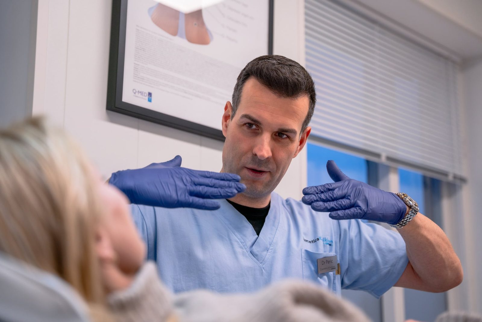 Legen forklarer en behandling for en pasient ved Cosmetica Klinikken